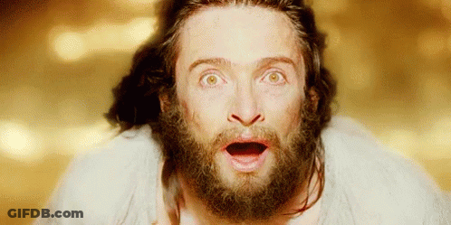 A Man With A Beard Has A Surprised Look On His Face . GIF