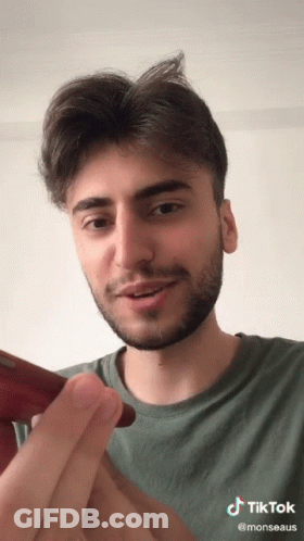 A Man With A Beard Has A Tiktok Sticker On His Face GIF