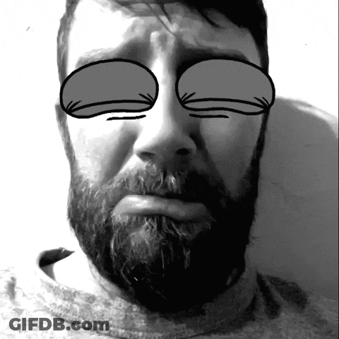 A Man With A Beard Has His Eyes Closed In A Black And White Photo GIF