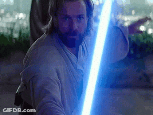 A Man With A Beard Holding A Blue Lightsaber GIF
