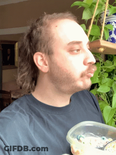 A Man With A Beard Holds A Plastic Container Of Food GIF