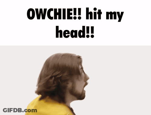 A Man With A Beard Holds His Hand To His Forehead With The Words Owchie Hit My Head Below Him GIF