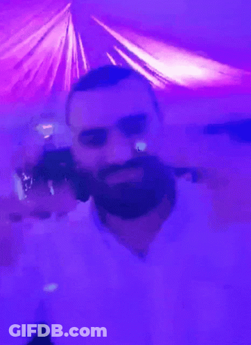 A Man With A Beard In A Purple Room GIF