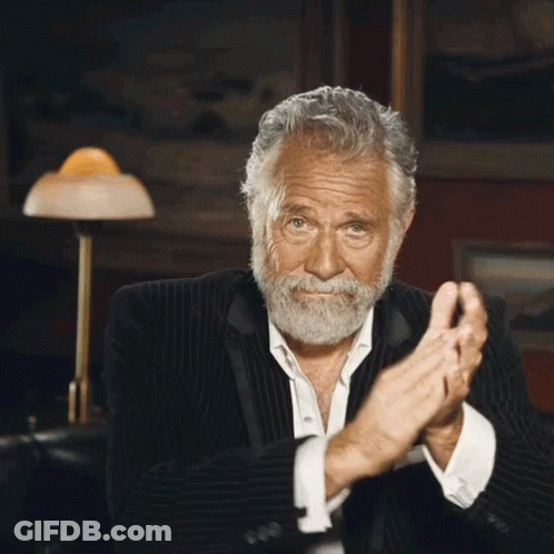 A Man With A Beard In A Suit Is Clapping His Hands GIF