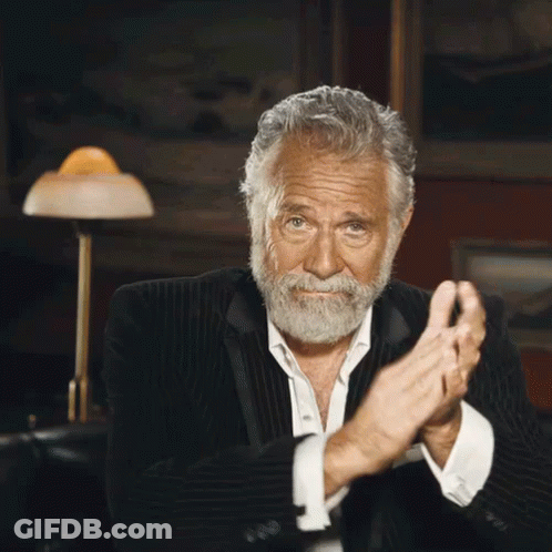 A Man With A Beard In A Suit Is Clapping His Hands GIF
