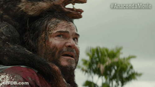 A Man With A Beard Is Being Attacked By A Monster With The Hashtag #Anacondamovie GIF