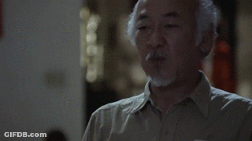 A Man With A Beard Is Blowing A Kiss GIF