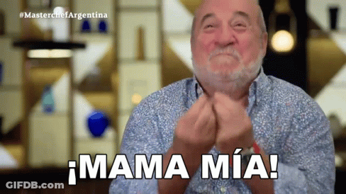 A Man With A Beard Is Clapping His Hands And Says Mama Mia GIF