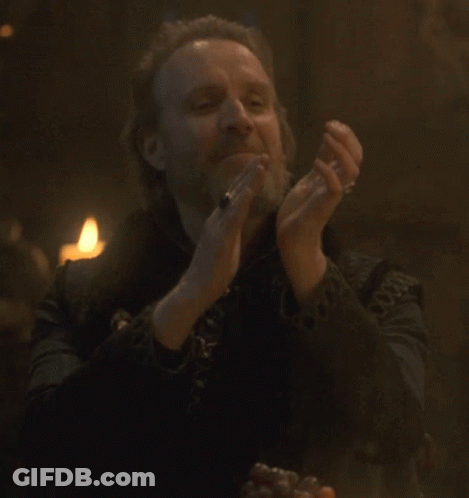 A Man With A Beard Is Clapping His Hands GIF