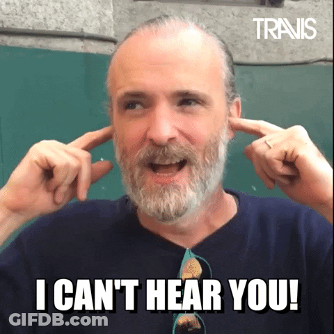 A Man With A Beard Is Covering His Ears With His Hands And Says " I Can T Hear You " GIF