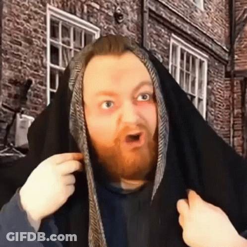 A Man With A Beard Is Covering His Head With A Black Cloth . GIF
