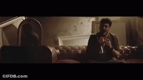 A Man With A Beard Is Crying While Sitting In A Car At Night . GIF