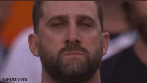 A Man With A Beard Is Crying With His Eyes Closed And A Tear Coming Out Of His Nose . GIF