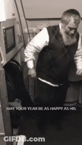 A Man With A Beard Is Dancing In A Room With The Words May Your Year Be As Happy As His On The Bottom GIF