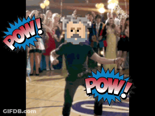 A Man With A Beard Is Dancing In Front Of A Crowd With A Pow Bubble Above Him GIF