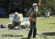 A Man With A Beard Is Dancing In The Grass GIF