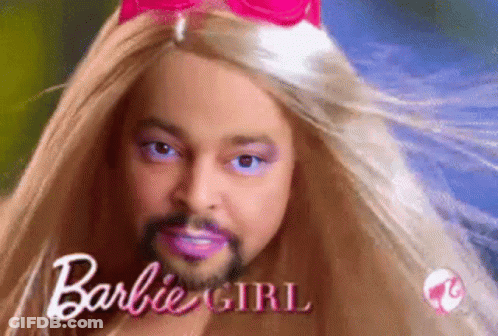 A Man With A Beard Is Dressed As A Barbie Doll With Long Blonde Hair . GIF