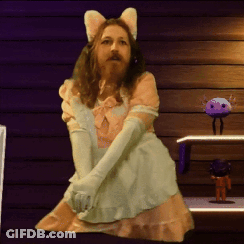A Man With A Beard Is Dressed In A Maid Costume GIF