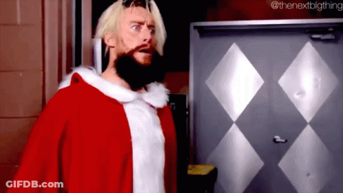 A Man With A Beard Is Dressed In A Santa Claus Costume . GIF