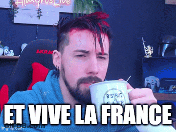 A Man With A Beard Is Drinking From A Mug That Says " Et Vive La France " On It GIF