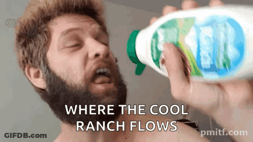 A Man With A Beard Is Drinking From A Spray Bottle With The Words " Where The Cool Ranch Flows " GIF