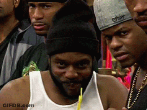 A Man With A Beard Is Drinking From A Straw In A Crowd Of People GIF