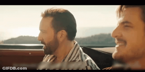 A Man With A Beard Is Driving A Car Next To Another Man With A Mustache GIF