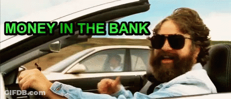A Man With A Beard Is Driving A Car With The Words Money In The Bank Below Him GIF