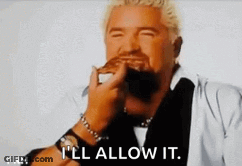 A Man With A Beard Is Eating A Hamburger With His Eyes Closed And The Words `` I 'Ll Allow It '' . GIF