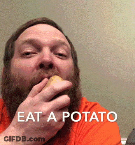 A Man With A Beard Is Eating A Potato With The Words " Eat A Potato " Above Him GIF
