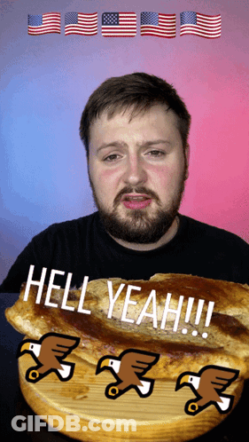 A Man With A Beard Is Eating A Sandwich With The Words Hell Yeah On It GIF