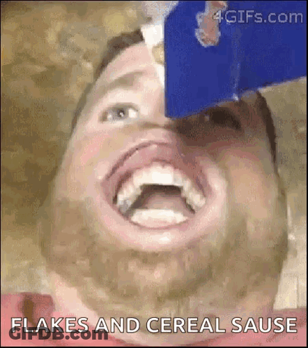 A Man With A Beard Is Eating Flakes And Cereal Sauce . GIF