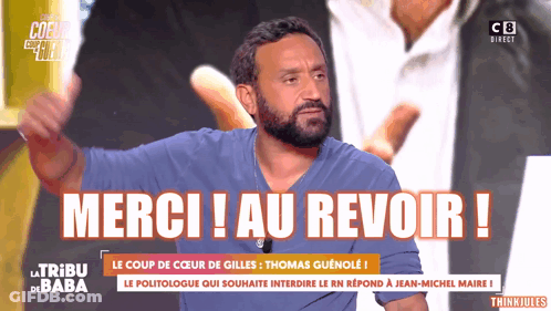 A Man With A Beard Is Giving A Thumbs Up In Front Of A Sign That Says " Merci Au Revoir " GIF