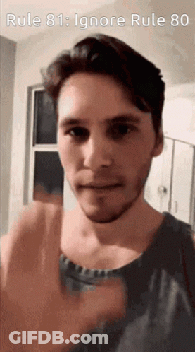 A Man With A Beard Is Giving A Thumbs Up In Front Of A Sign That Says Rule 81 : Ignore Rule 80 GIF