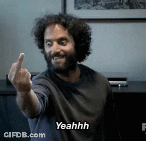 A Man With A Beard Is Giving The Middle Finger And Says Yeahh On The Bottom GIF
