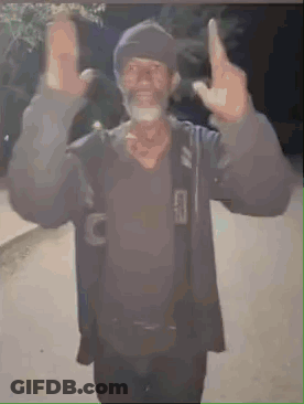 A Man With A Beard Is Giving The Middle Finger While Wearing A Hat . GIF