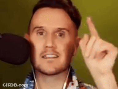 A Man With A Beard Is Giving The Middle Finger While Wearing Headphones And A Microphone . GIF