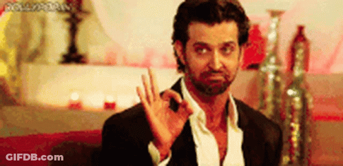 A Man With A Beard Is Giving The Ok Sign With His Hand . GIF