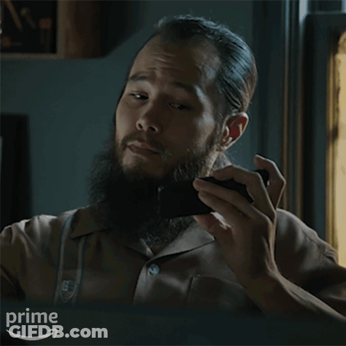 A Man With A Beard Is Holding A Black Object And Asking What Do You Think GIF