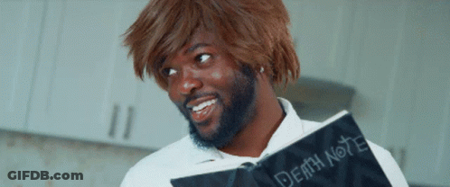 A Man With A Beard Is Holding A Book Called Death Note GIF