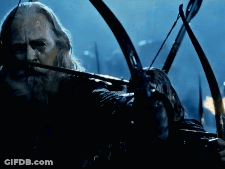 A Man With A Beard Is Holding A Bow And Arrow And The Word Twang Is Visible GIF