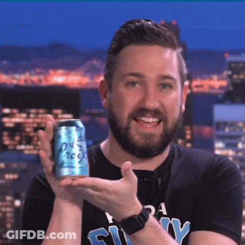 A Man With A Beard Is Holding A Can Of Soda That Says " Old Rock " GIF