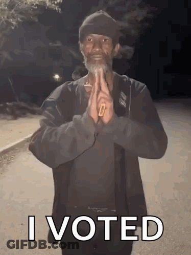 A Man With A Beard Is Holding A Cigarette In His Hand And Says " I Voted " GIF