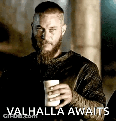 A Man With A Beard Is Holding A Cup Of Coffee And The Words `` Valhalla Awaits '' . GIF