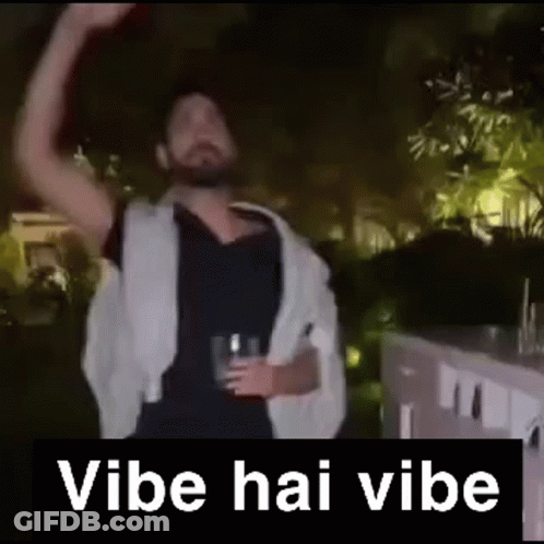A Man With A Beard Is Holding A Glass Of Beer And Dancing In A Video . GIF