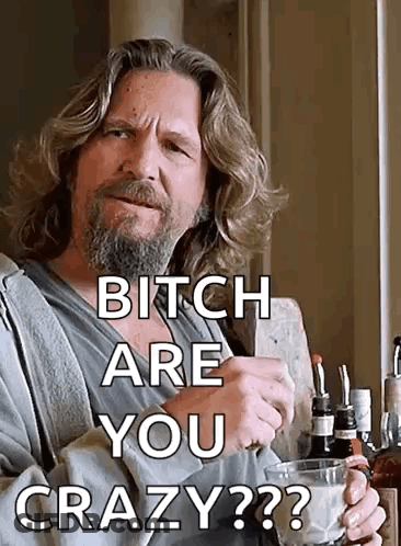 A Man With A Beard Is Holding A Glass Of Milk And Says " Bitch Are You Crazy " . GIF
