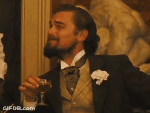A Man With A Beard Is Holding A Glass Of Wine GIF