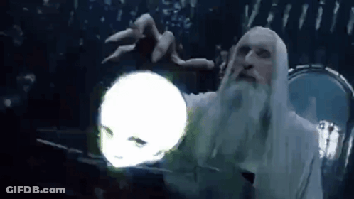 A Man With A Beard Is Holding A Glowing Ball In His Hand . GIF