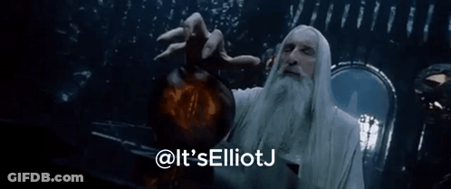 A Man With A Beard Is Holding A Glowing Object And Says It 'S Elliotj GIF