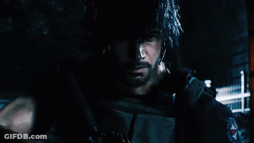 A Man With A Beard Is Holding A Gun In A Dark Room GIF